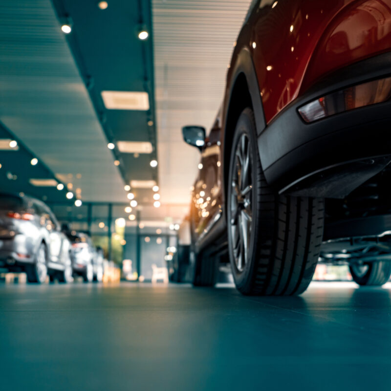 automotive industry = cars lined up in a showroom